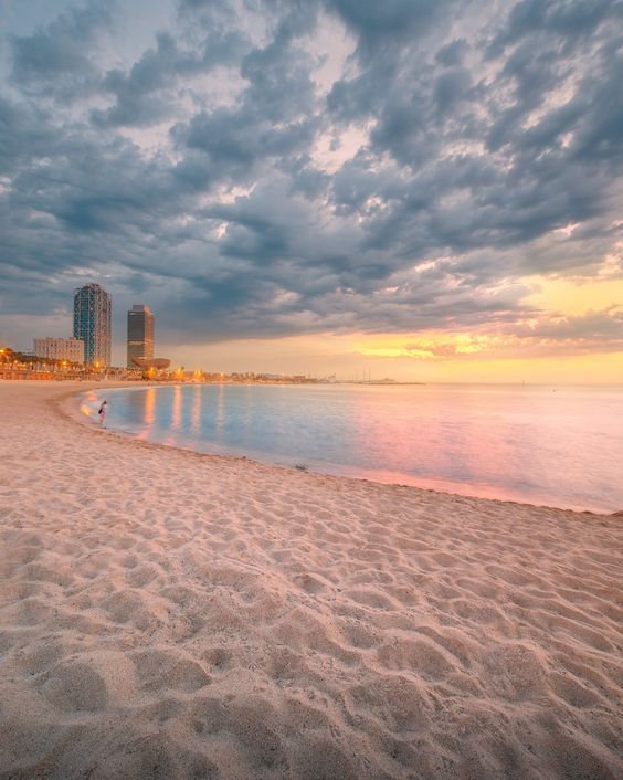 Barceloneta Beach in Barcelona with colorful sky at sunrise